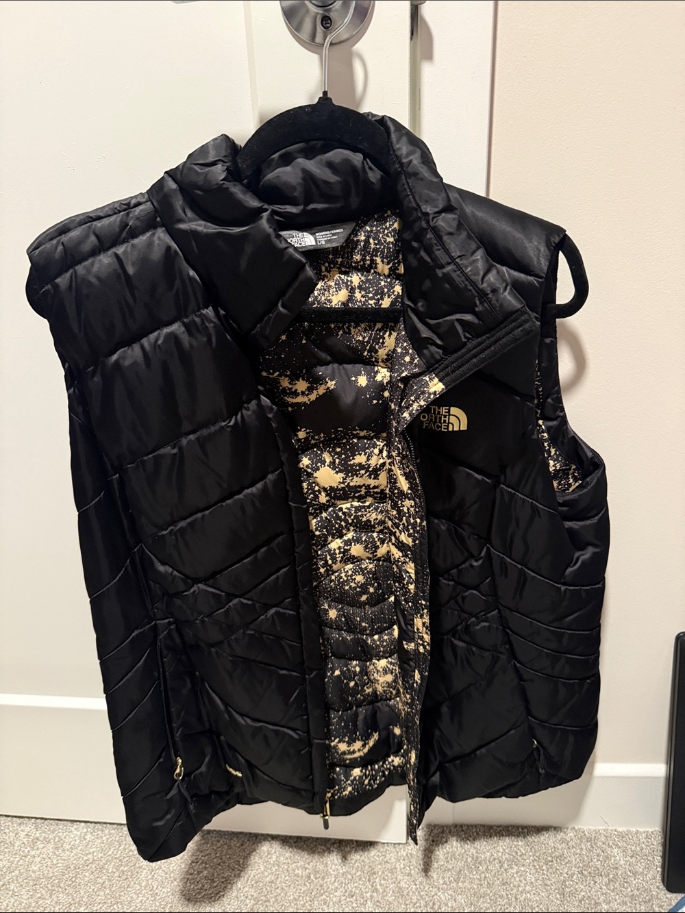 The North Face Kids Black Puffer Vest with Gold-Speckle Lining
